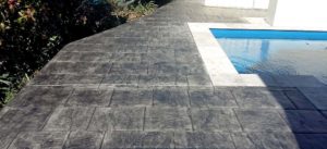 Using stamped concrete with the travertine edge gives a premium look for your pool for a lot less than more expensive materials.